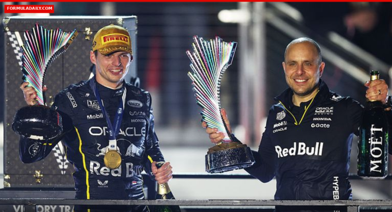 Max Verstappen and race engineer Gianpiero Lambiase celebrating with trophies on the podium in Red Bull Racing gear